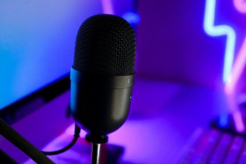 Professional condenser microphone in a neon-lit streaming setup