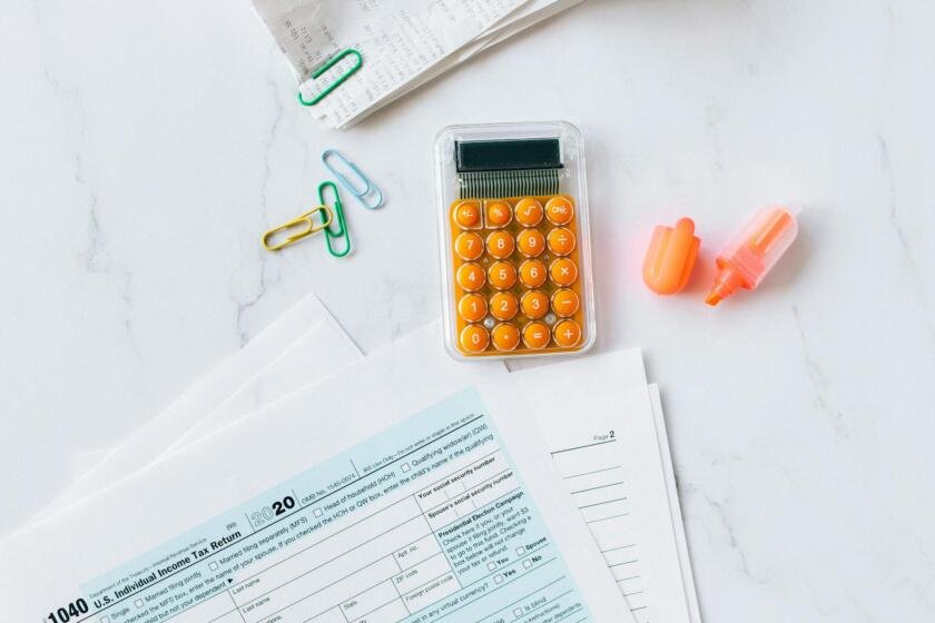 Desk with tax documents and calculator — OnlyFans taxes for creators